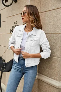 Detail of white slim denim jacket with turn-down collar and metal chest pockets