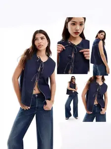 Women's dark blue denim set featuring a lace-up sleeveless vest and wide-leg trousers