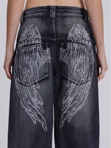 Vintage gray high-waisted wide leg jeans with white angel wing print and studs on back