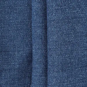 Detailed macro texture of deep blue denim fabric with classic twill weave and white cotton specks