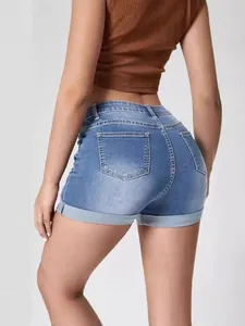 Women's blue denim shorts featuring trendy distressed details and cuffed hem on back view