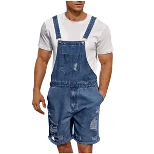 Detail of ripped blue denim bib overalls for men with adjustable straps and front pocket