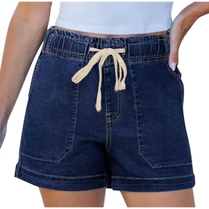 Detail shot of dark blue denim shorts with elastic drawstring waist and large pockets
