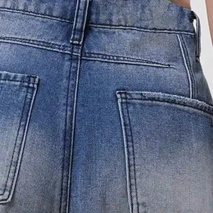 Macro detail of retro washed blue denim jeans showing back pocket and sturdy stitching