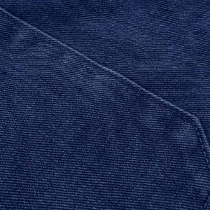 Close-up of dark blue denim fabric showing detailed stitching and fine twill texture