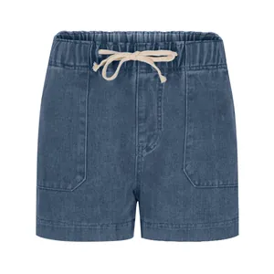 Detailed view of elastic waistband and cream drawstrings on casual denim shorts