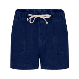 Detail of dark blue denim shorts featuring elastic waist, drawstring and large side pockets