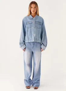Front view of light blue denim jacket with lapels and matching wide-leg jeans outfit