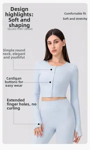 Detail of light blue yoga cardigan featuring button closure and functional thumbholes