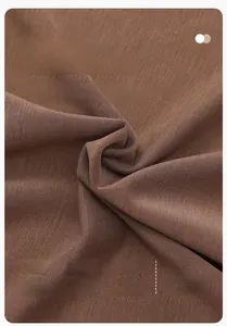 Detail of coffee brown fabric composed of 51% EcoCosy, 42% polyester and 7% spandex