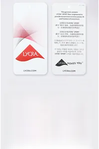 Detailed view of official Lycra Sport fabric tags highlighting performance and elasticity