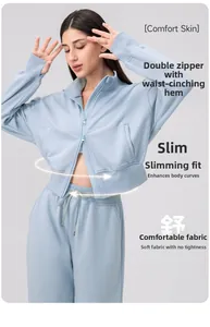 Detail showing the double-end zipper and cinched waist hem on light blue yoga jacket