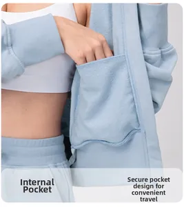 Detail of inner safety pocket on light blue zip-up yoga jacket for women