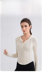 Detail of cream yoga hoodie featuring half-zipper neckline and ribbed elastic fabric