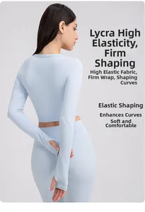 Detail of light blue yoga top with thumbhole cuffs and stretchy Lycra fabric