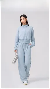 Detail of light blue yoga track jacket with thumbhole cuffs and high neck zip closure