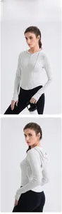 Front and back detail of slim fit light gray hooded yoga top with half-zipper design