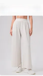 Detailed view of high-waist wide-leg lounge pants with elasticated waistband in cream