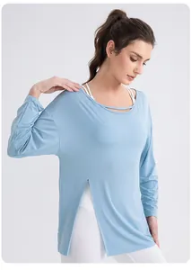 Detail of light blue yoga top with side slit and cutout neckline on white background