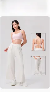 Detailed back view of pink cross-strap yoga bra with wide-leg white trousers set