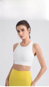 Front view of white high-neck racerback sports bra paired with yellow yoga leggings