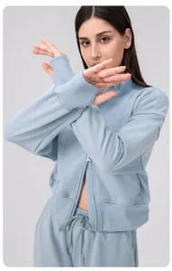 Detail of light blue sports jacket with zipper and ribbed cuffs on the sleeve