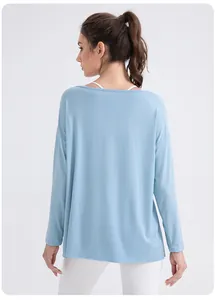Detail of light blue modal yoga top showing breathable soft fabric and loose fit comfort