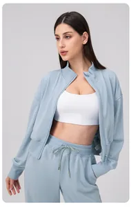 Detail of light blue women's zip-up sports jacket with soft cotton blend fabric texture