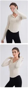 Detail of beige ribbed yoga hoodie with thumbholes and slim-fit curved hem design