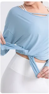 Close-up of light blue modal yoga top featuring a self-tie hem and breathable fabric