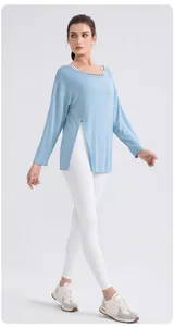 Detail of light blue modal yoga top featuring elegant side slit and strappy neckline detail