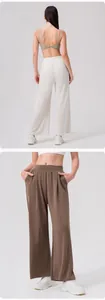 Detail of high waist wide leg pants with elastic waistband and pockets in white and coffee