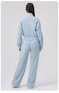 Back view of light blue yoga tracksuit with stand collar zip jacket and wide leg pants