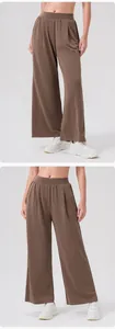 Detail of high waist elastic waistband and soft brown fabric drape on wide leg sports pants