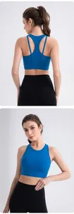 Detail of royal blue racerback sports bra and high-waisted black yoga leggings on model
