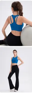 Detail of navy blue racerback sports bra and black high-waisted flared yoga pants