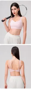 Detailed back view of pink yoga bra with crisscross twist design and slim straps