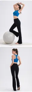 Detail of high-impact royal blue yoga bra with cutout back and black flared leggings