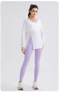 Detail of white modal yoga top with asymmetrical slit hem and crisscross neckline design