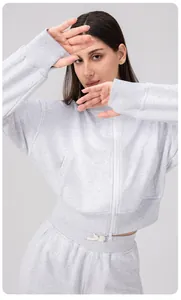 Detail of grey zip-up sports jacket with ribbed cuffs and elastic drawstring waistband