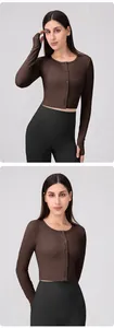Detail of long sleeve yoga top featuring thumbhole cuffs and button-front neckline closure