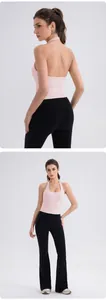 Front and back view of a pink halter yoga top and black flared high-waist sports leggings