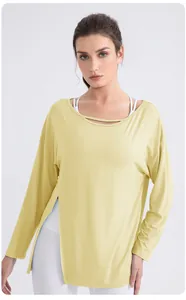 Detail of light yellow modal yoga top featuring hollow neckline and high side slit design