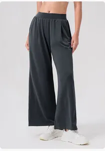 Detail of high-waist elastic waistband and soft draping fabric on dark grey wide-leg pants