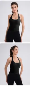 Detail of a black halter neck yoga top with cross-back design and fitted sports leggings