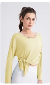 Detail of light yellow modal yoga top with hollow neckline and side knot design