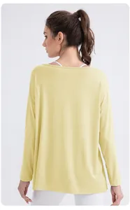 Detail of loose-fit light yellow modal yoga top with long sleeves and soft breathable fabric