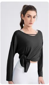 Close-up of black modal yoga top with cutout neckline and stylish waist tie design
