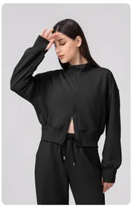 Detail of double-way zipper on women's loose fitness jacket with ribbed cuff and high collar