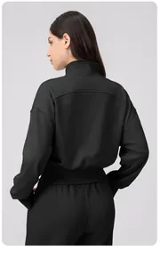 Back view of a black women's slim fit zip-up sports jacket and athletic trousers set